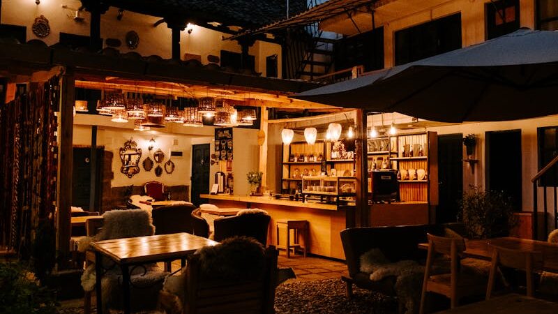 Cozy courtyard café with warm lighting in historic Cusco, Peru, during twilight.