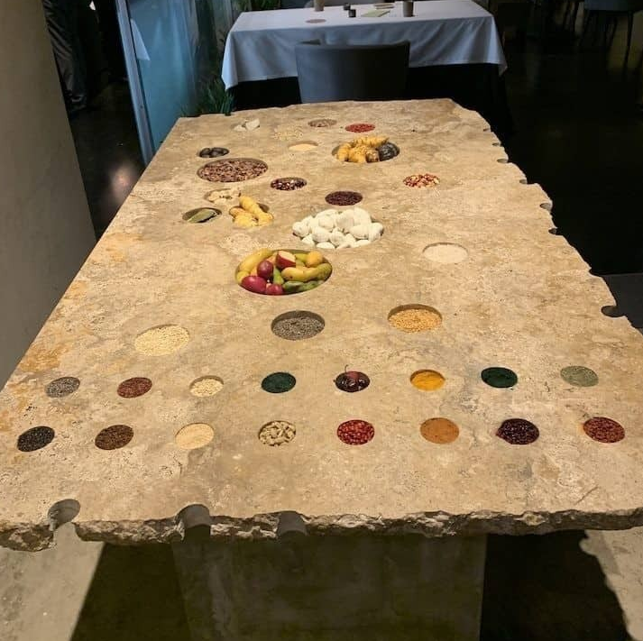 Sabores del Perú A traditional Peruvian woman with a llama against a brick wall in Cusco, Peru.